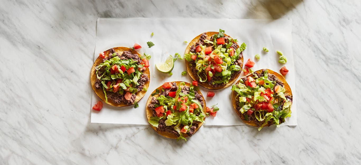 Quick Black Bean Tostadas on a marble background