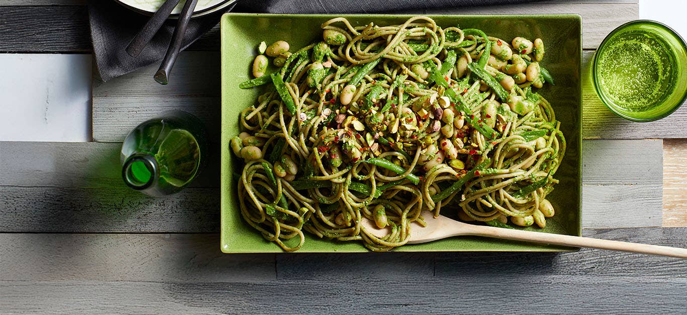 Green Bean Pasta with Cashew Pesto in a green ceramic serving platter