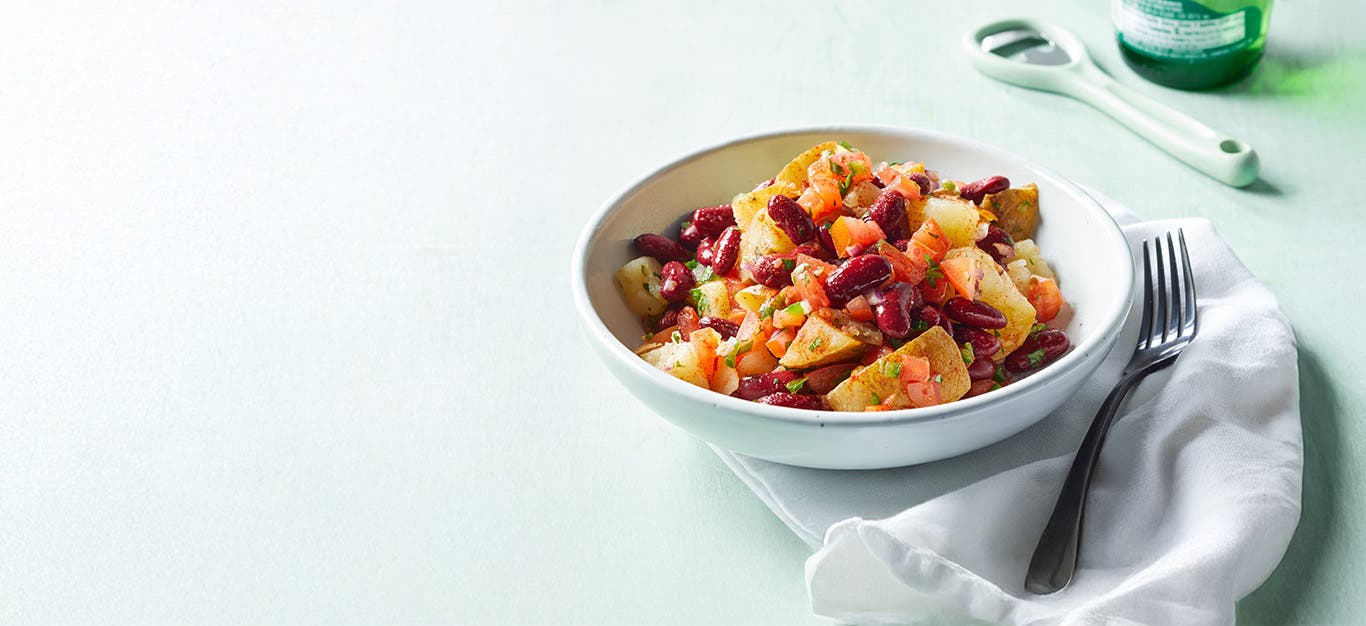 Southwest Potato and Red Bean Bowl against a pale green background