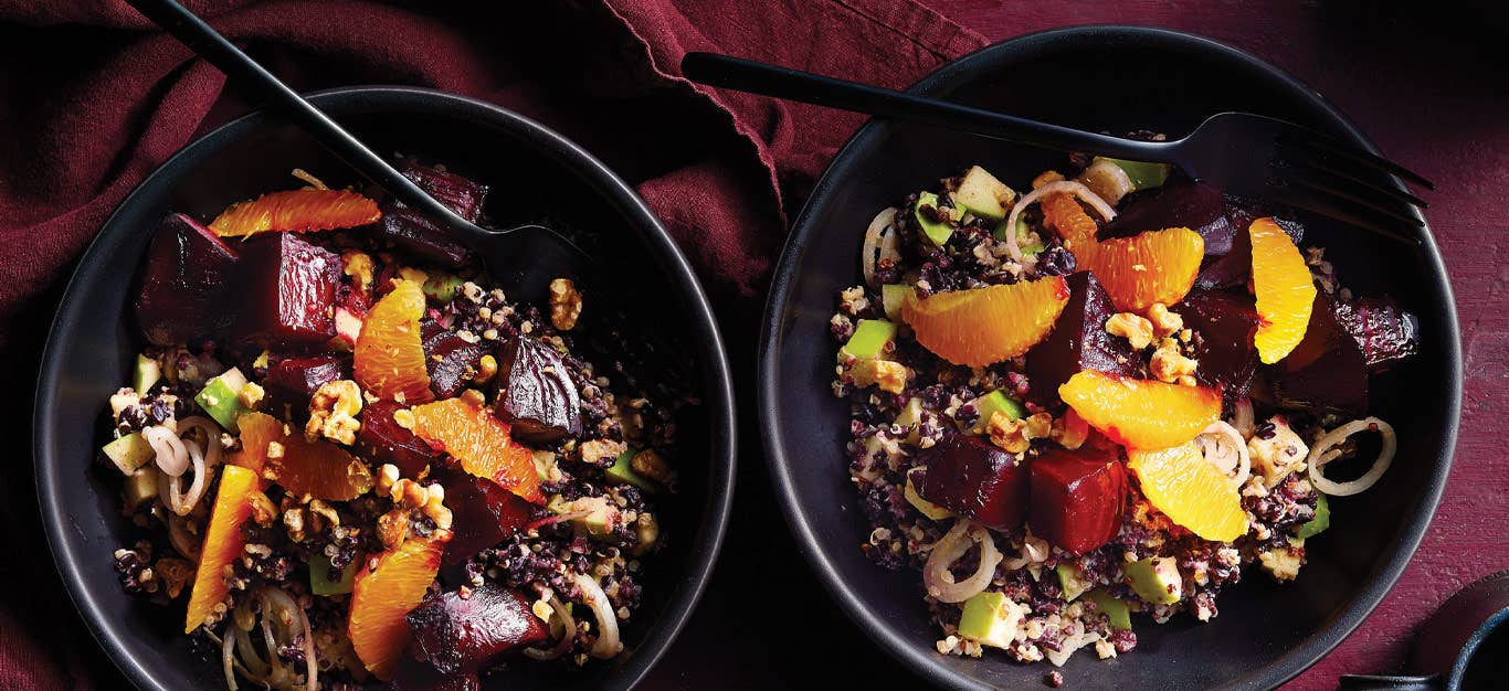 Black Rice, Roasted Beet, and Orange Salad in black ceramic bowls