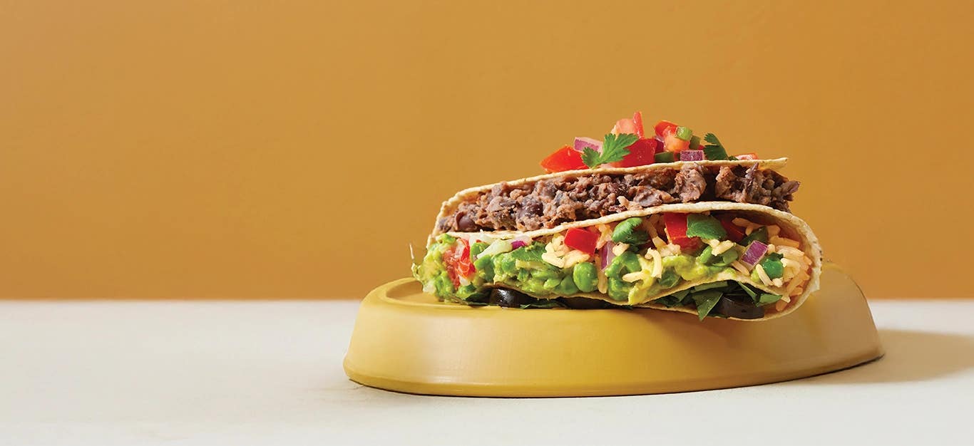 A Fold-Up Rice and Black Bean Quesadillas on an upturned plate against a mustard background