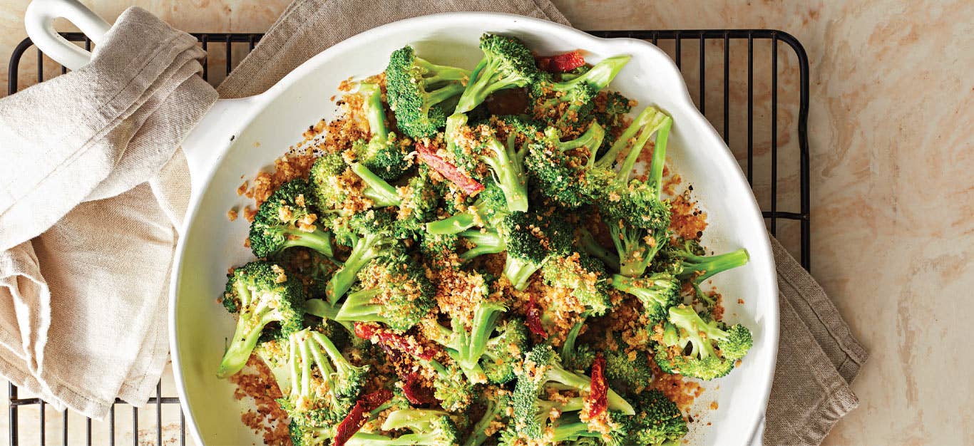 Panko Broccoli with Sun-Dried Tomatoes in a white ceramic skillet on wire cooling rack
