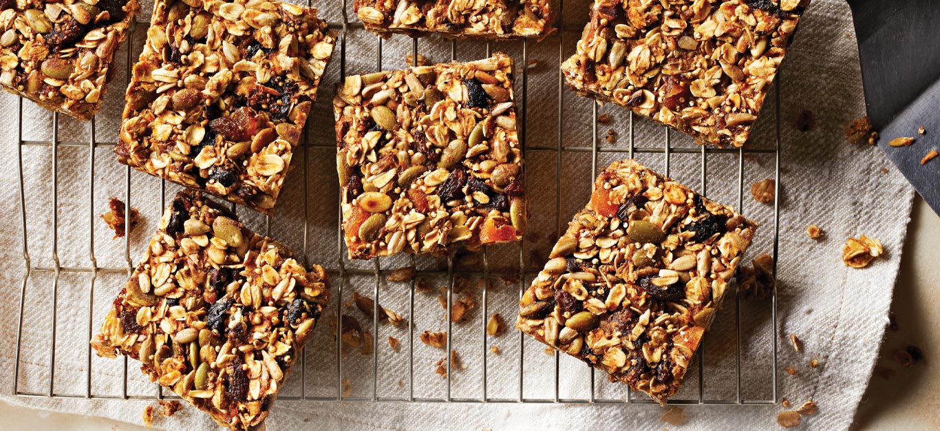 Crunchy Grain, Seed, and Dried Fruit Bars on a metal cooling rack
