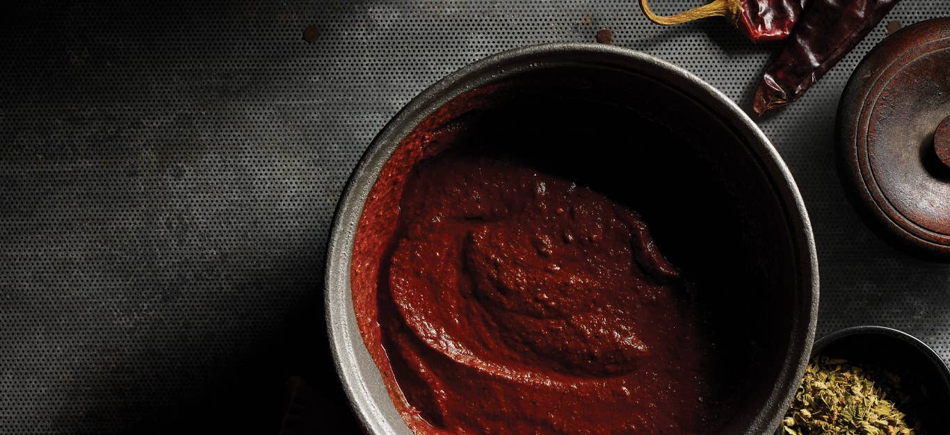 Easy Mole Sauce in a gray ceramic bowl against a dark gray background