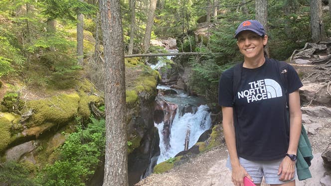 Young mom Chelsey Williams poses on a hiking trail after reclaiming her health by adopting a WFPB diet to relieve Crohn's symptoms