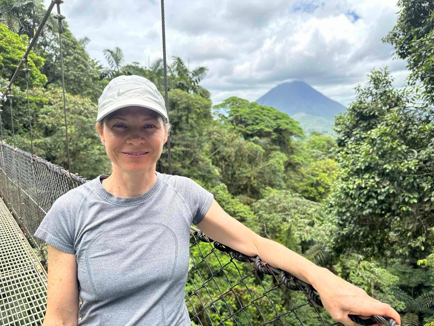 Radiation Oncologist Isabelle Vallieres stands on a bridge in a jungle looking healthy after adopting a plant-based diet for ibd