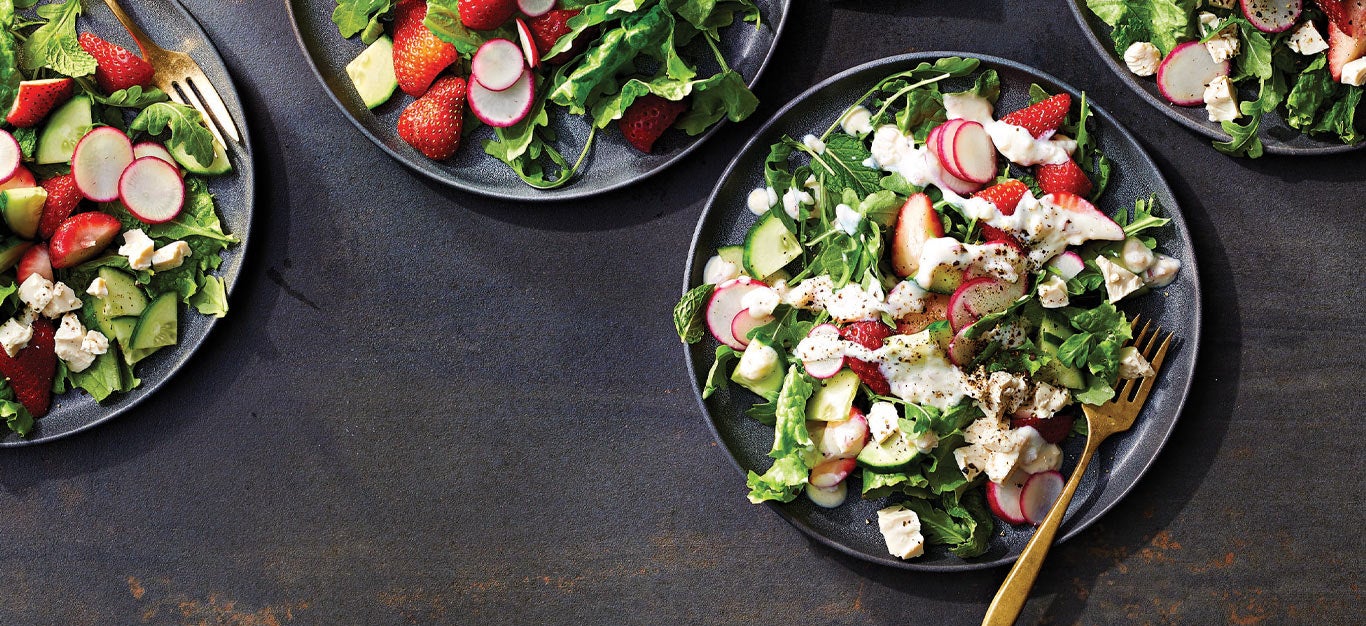 Strawberry-Radish Salad with Creamy Lemon Dressing on dark gray ceramic plates