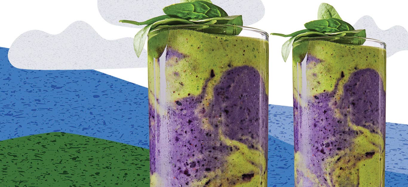 Ultimate Earth Day Smoothie in tall clear glasses with a garnish of spinach leaves against a cartoon background of mountains and clouds
