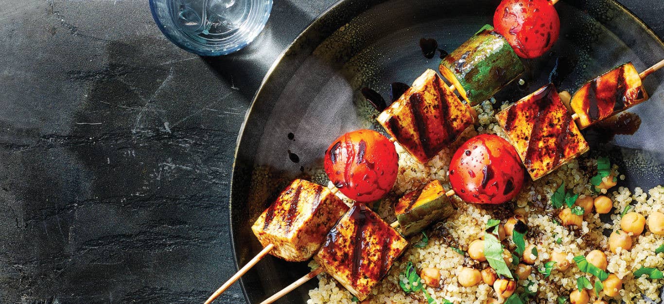 Grilled Tofu Kabobs with Rhubarb-Balsamic Glaze and Quinoa Pilaf in a stainless steel pan on a a dark countertop