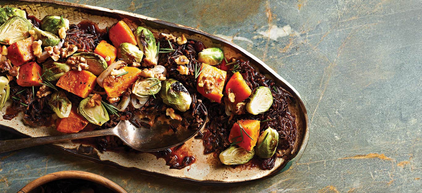 Cranberry Wild Rice with Sweet Potato and Brussels Sprouts on a long pottery serving dish