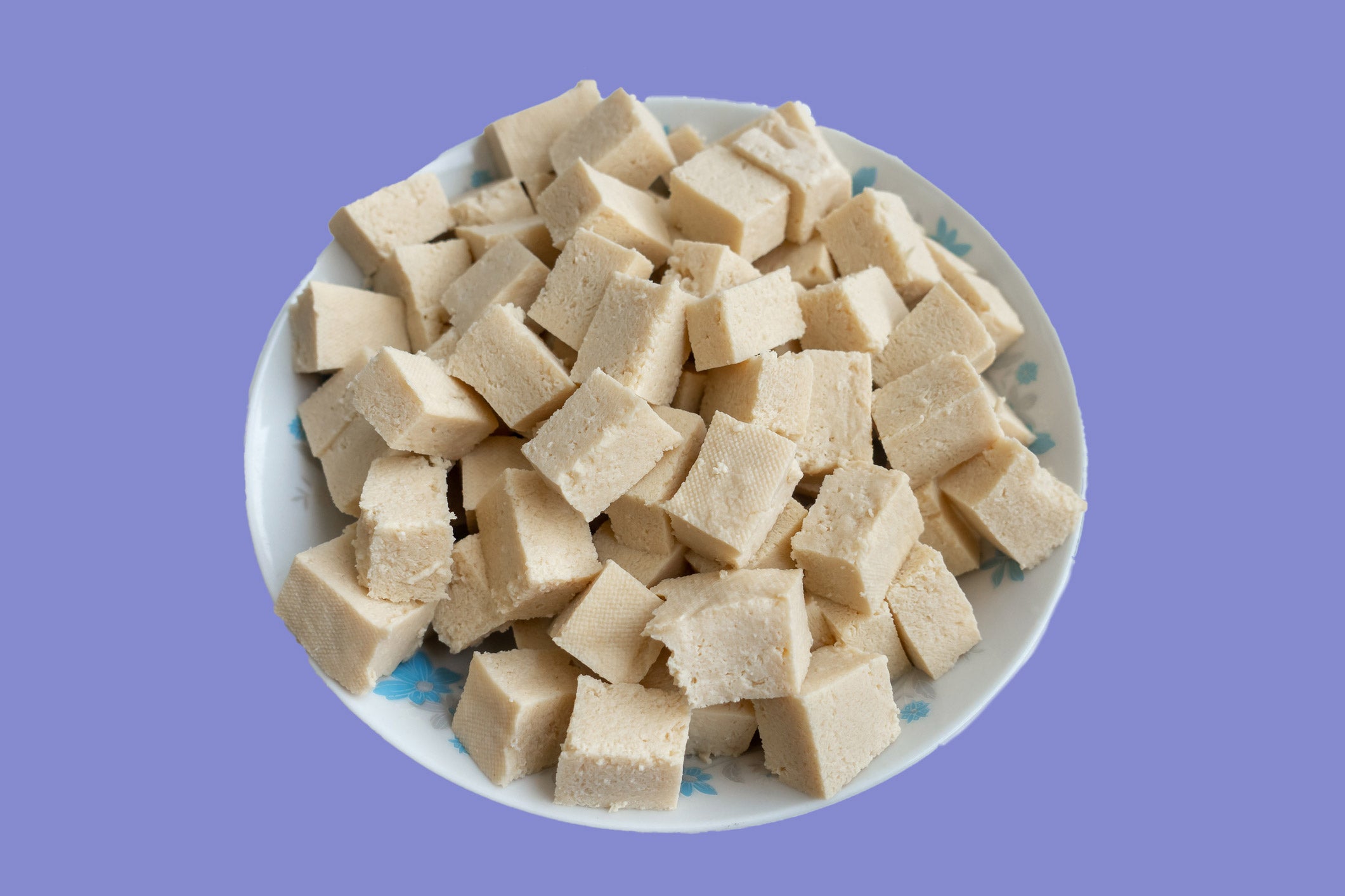 frozen tofu in a bowl on a blue background