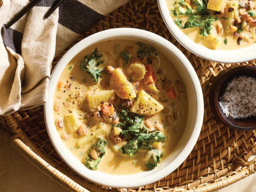 Two white serving bowls of Potato-Kale Black-Eyed Pea Soup
