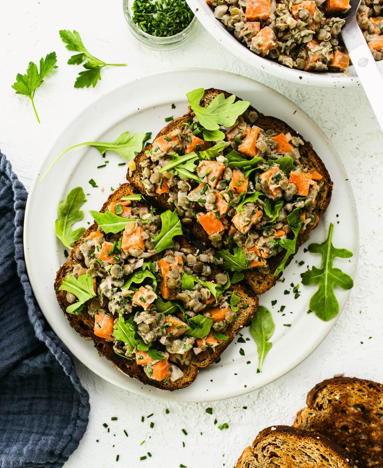 To slices of whole grain toast topped with Maple Mustard Lentils, Sweet Potatoes, and Herbs