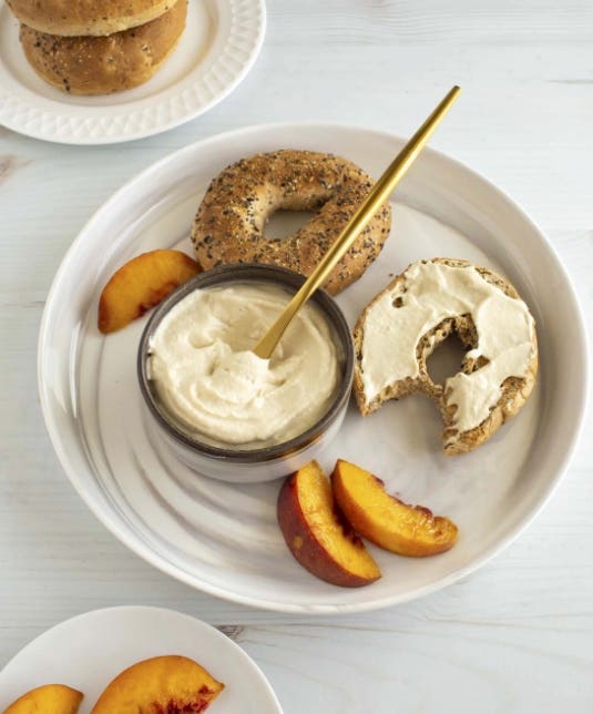 Whole grain bagels spread with homemade vegan cream cheese by Brandi Doming