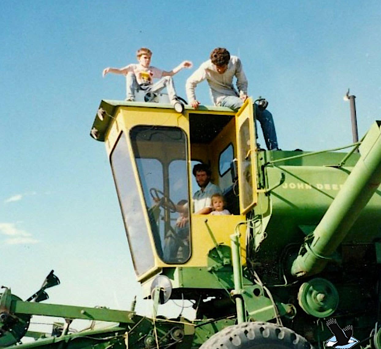 The Stelzer family i and on the cab of a large harvesting machine at Azure