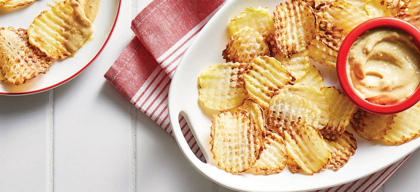 Waffle Fries with Dipping Sauce on a plate with a small bowl of dipping sauce