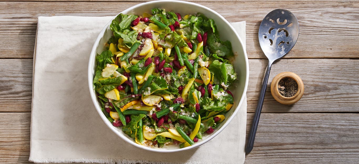Green Beans and Summer Squash Salad on a folded cloth napkin on wooden table