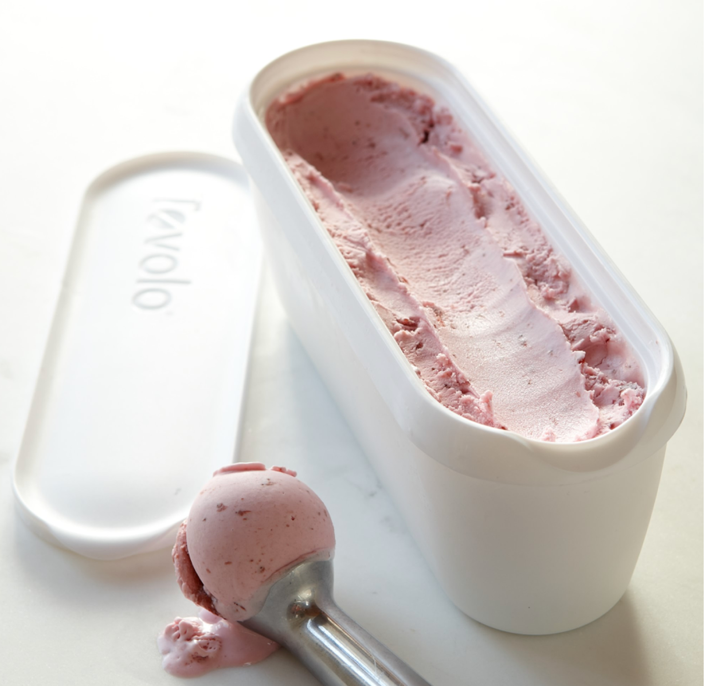 Ice Cream Storage Tub filled with strawberry ice cream with a stainless steel scoop beside the container
