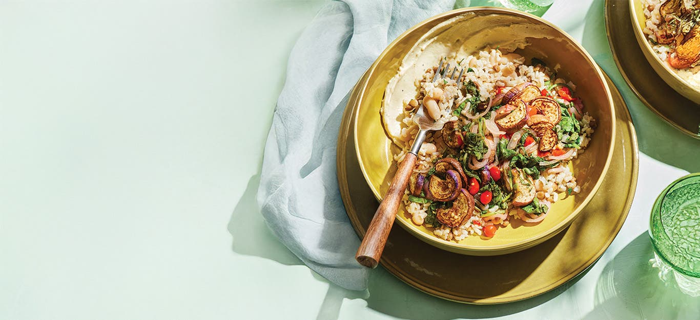 A plate of Sautéed Eggplant with Hearty Grains and Lemon-Garlic Aioli