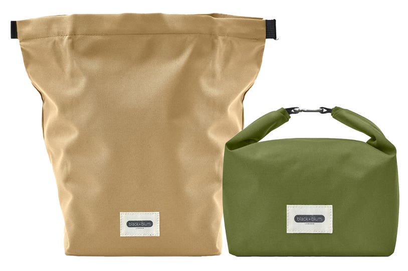Two insulated lunch bags from Black + Blum. The beige bag on the left is full extended yo, while the green bag on the right is folded down and clipped at the top to form a handle.
