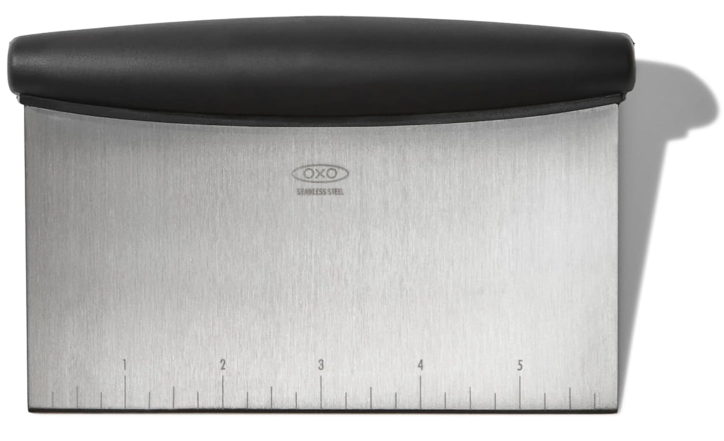 Closeup of an Oxo Bench Scraper with a black rubber grip