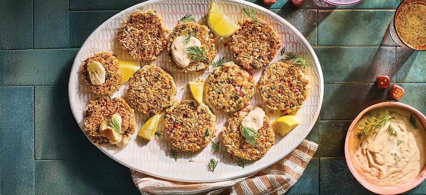 Vegan Crab Cakes on a platter with a small bowl of Remoulade to the side