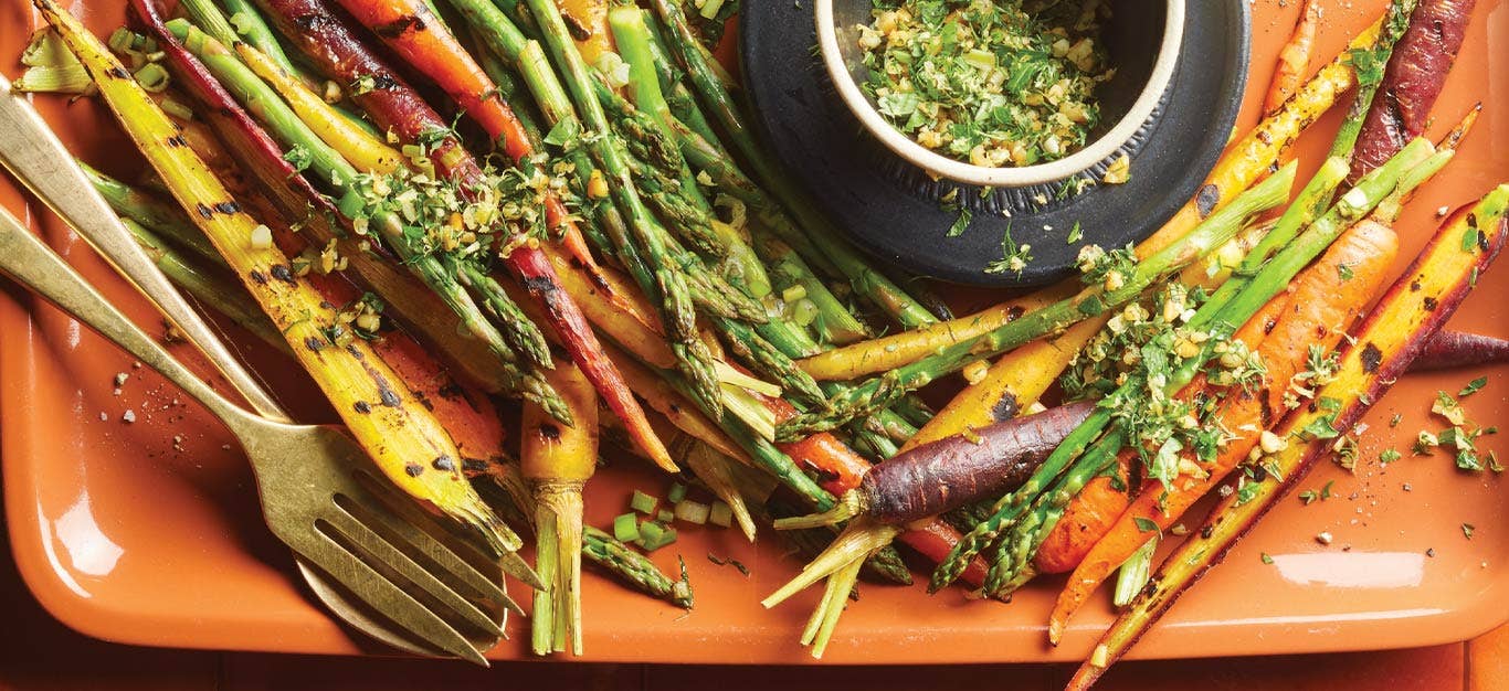 Grilled Asparagus and RainbowCarrots with Gremolata on an orange plastic serving tray