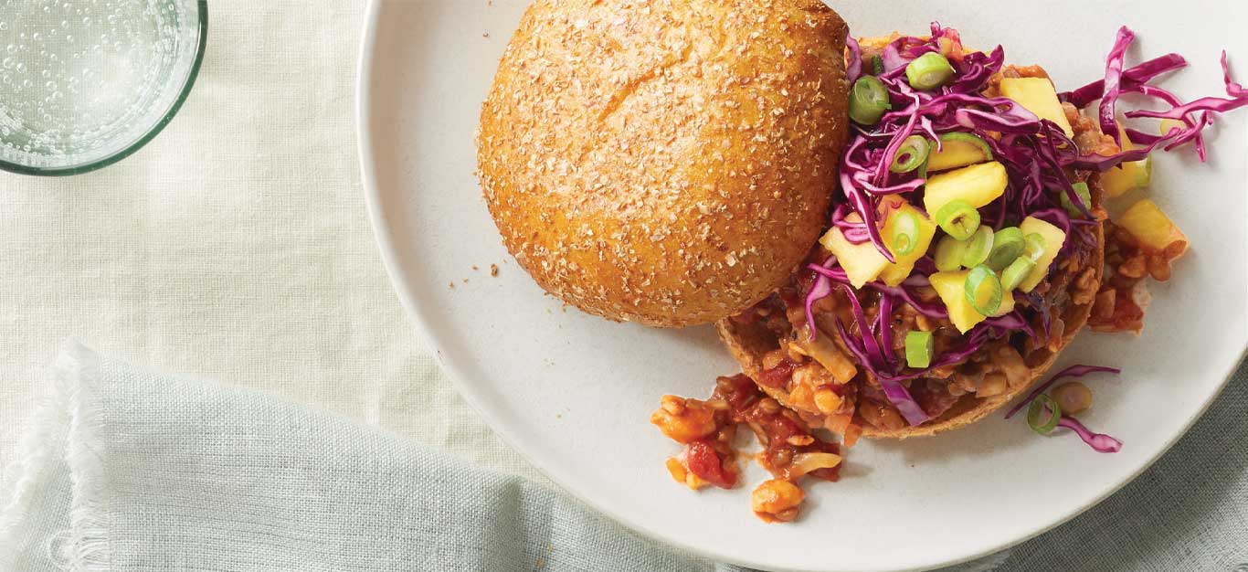 Tempeh BBQ Sandwiches with Pineapple Slaw on a white plate