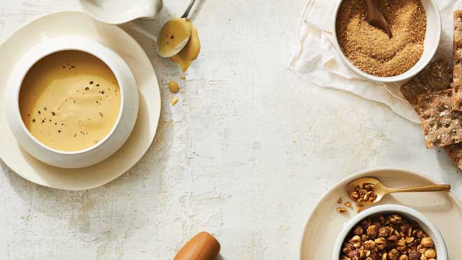 homemade cheese Vegan cheese sauce, crumbles, and sprinkles in white bowls