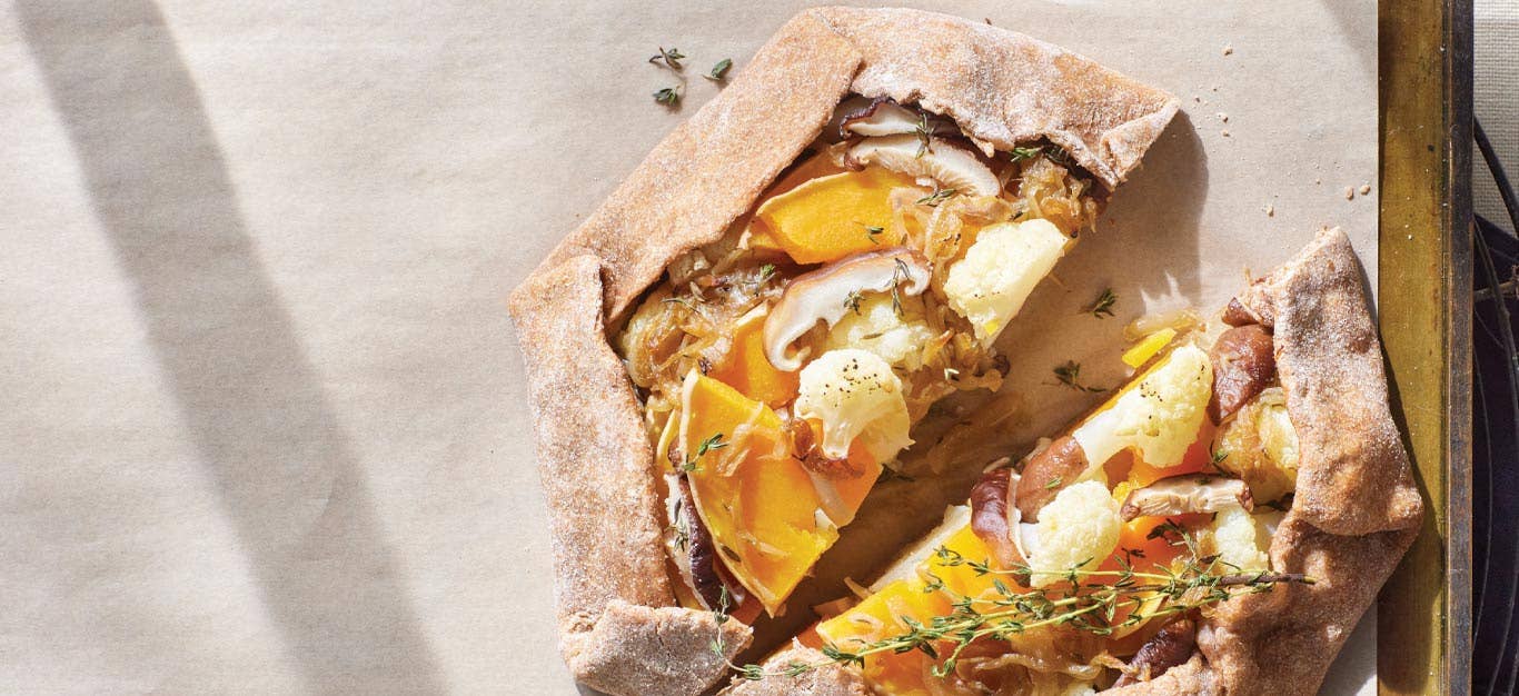 Vegan Galette with Caramelized Onion and Vegetables on parchment paper