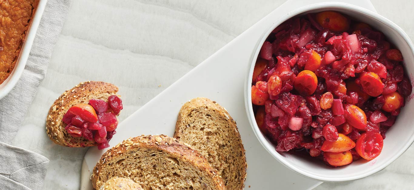 Cranberry-Kumquat Chutney in a small white bowl with sliced bread