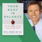 Neal Barnard next to a copy of his book "Your Body in Balance"