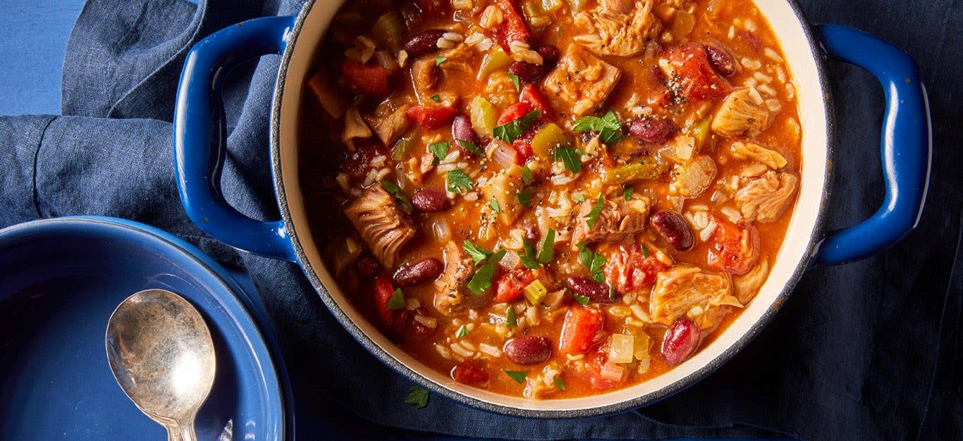 Jackfruit Vegan Jambalaya in a large pot with a spoon to the side - Hearty vegan fall stew