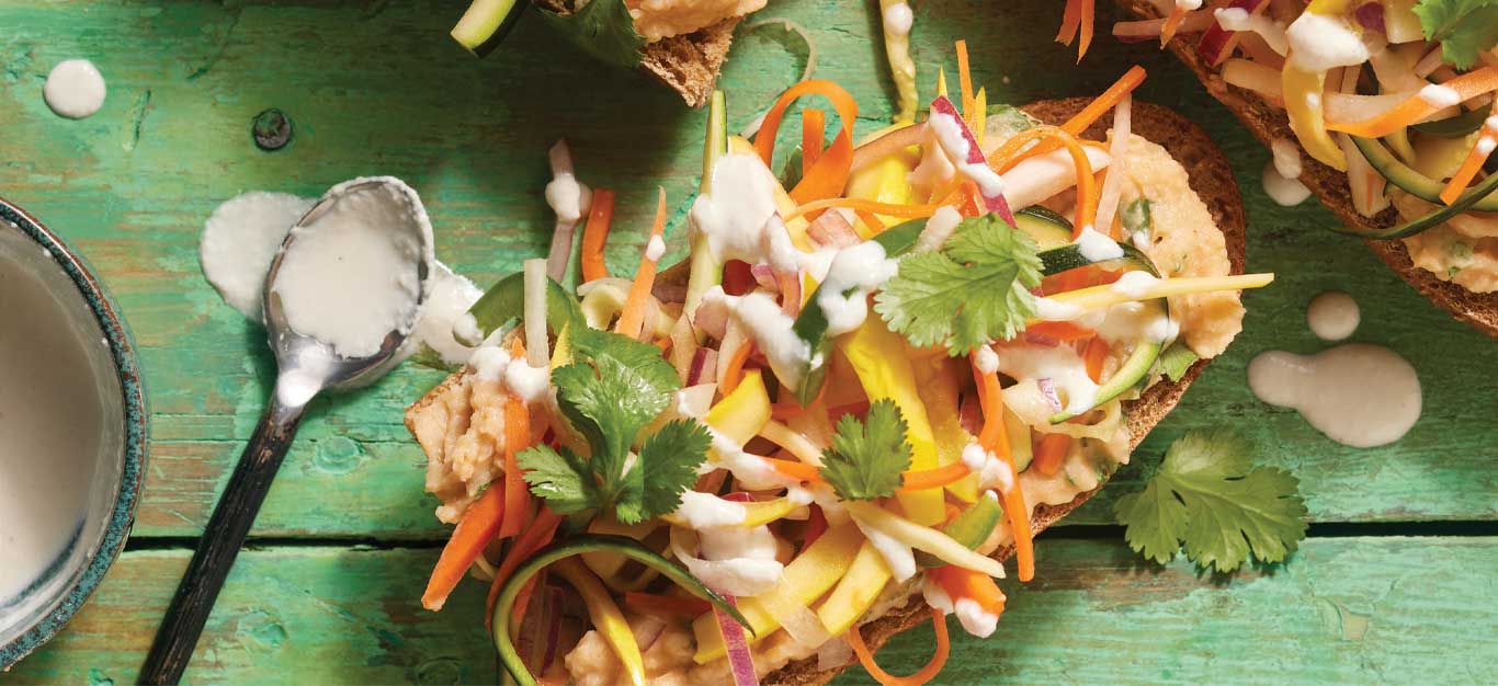 Open-Face Vegan Banh Mi Sandwiches on a green wooden table