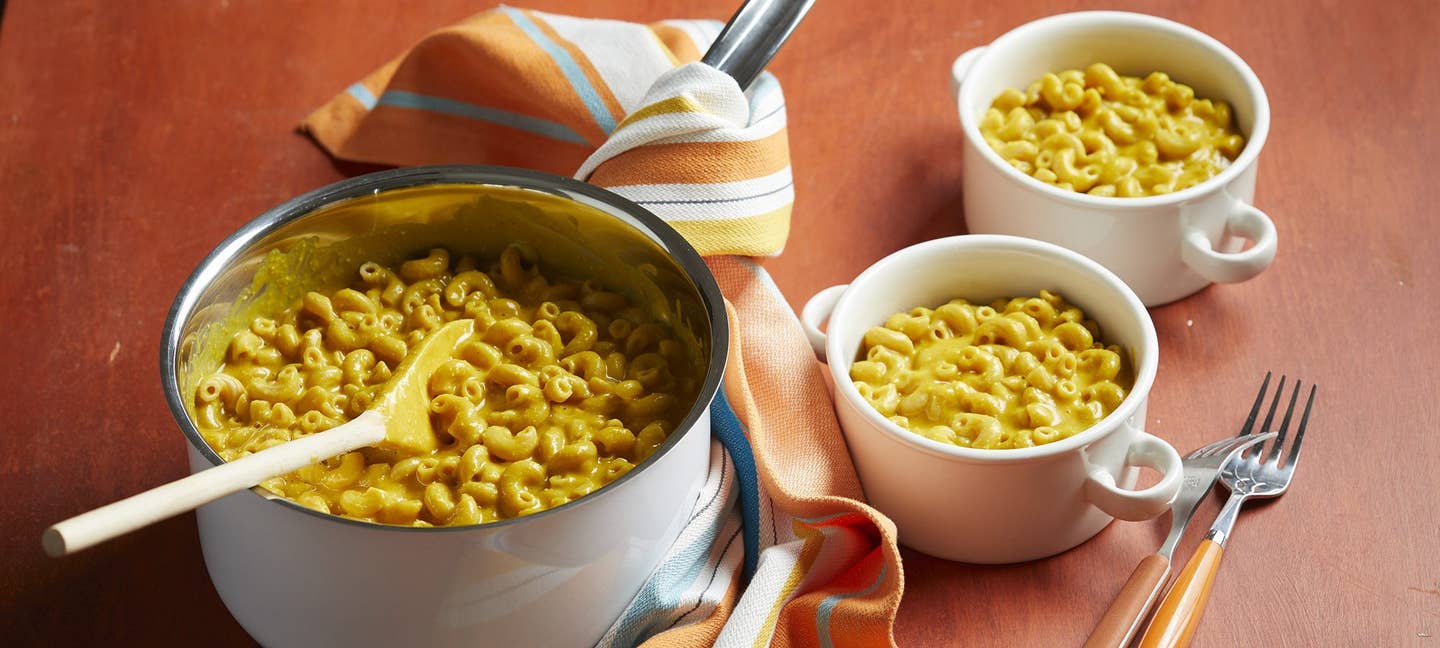 Stove-Top Mac and Cheese in a metal bowl on an orange tablecloth