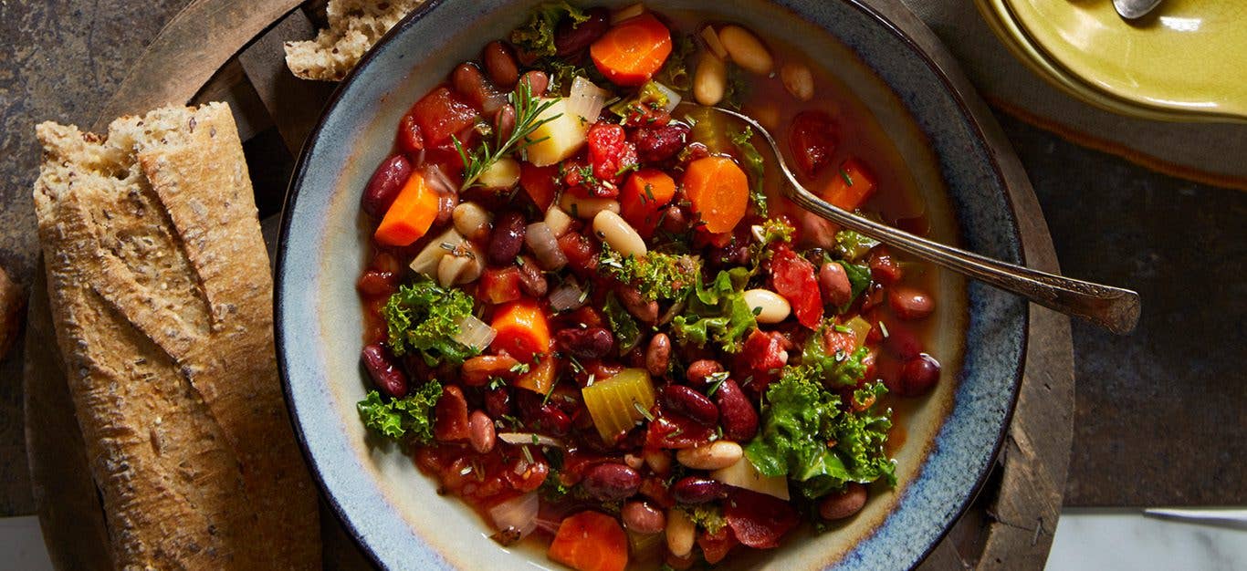 vegan cassoulet cooked in slow cooker with red beans, kidney beans, kale, carrots and more