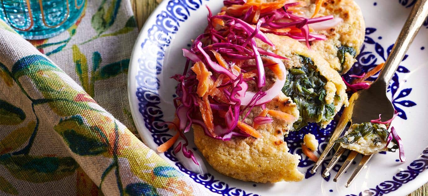 Vegan Spinach and Cheese Pupusas with Red Cabbage Slaw on a blue and white porcelain plate