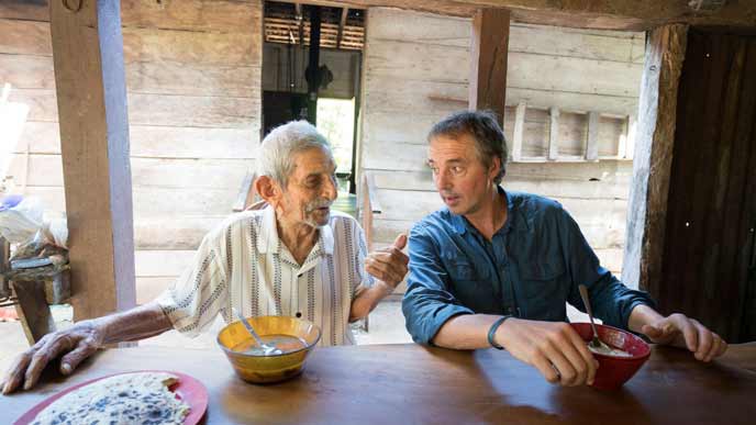 Dan Buettner talks to an elderly man in one of the world's Blue Zones - still taken from upcoming Netflix series Secrets of the Blue Zones