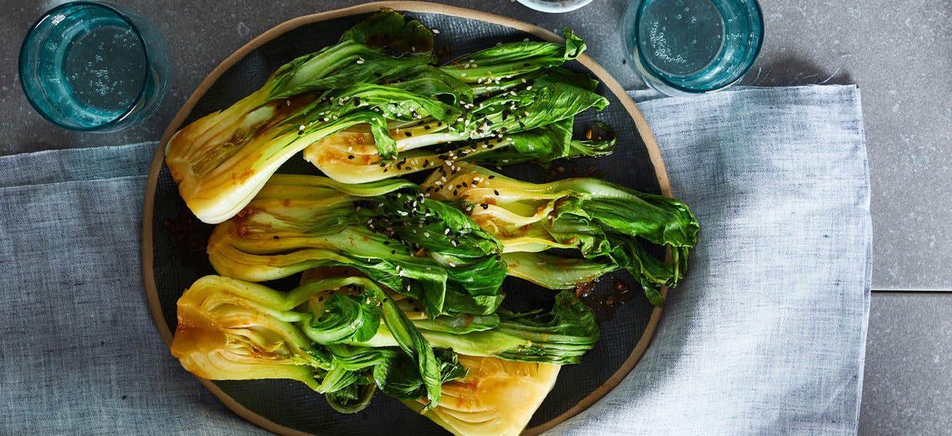 A plate of six bok choy halves in ginger garlic sauce