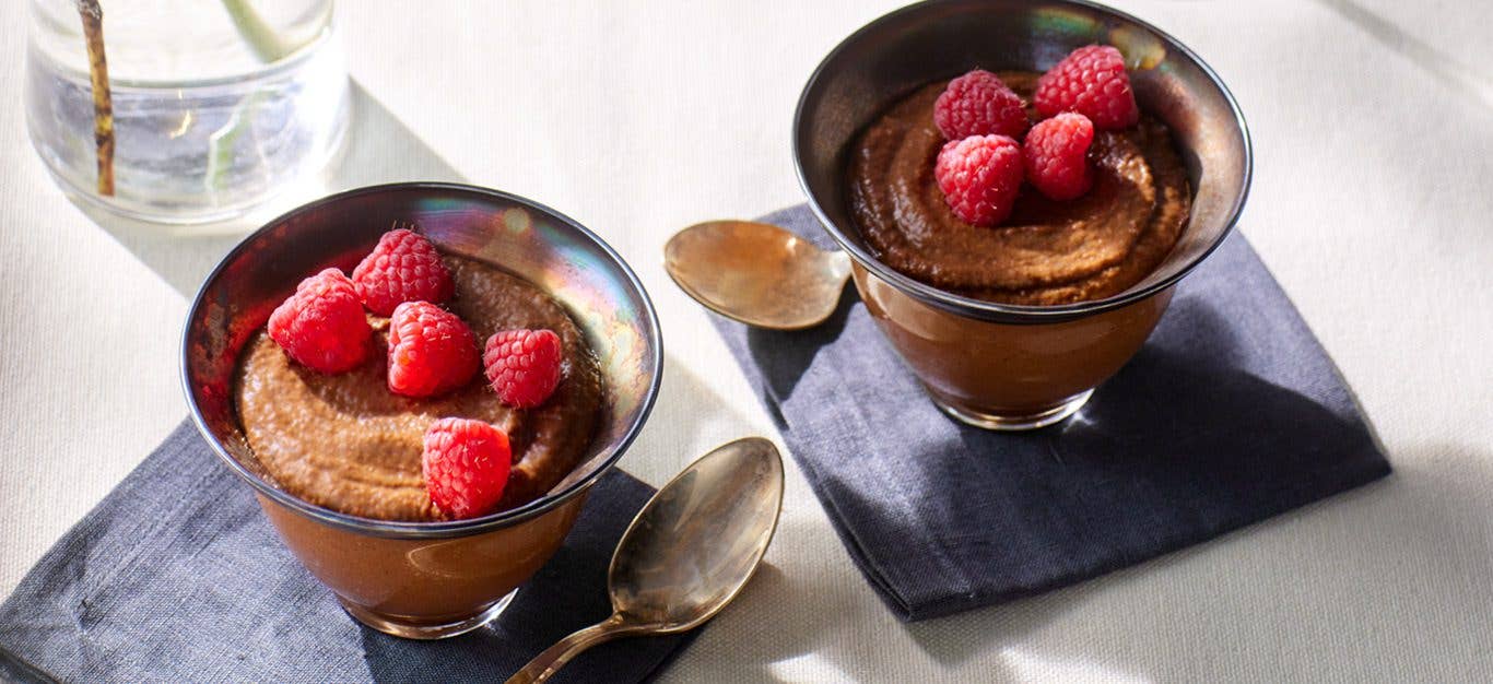 Vegan Chocolate Mousse in a tin bowl topped with raspberries