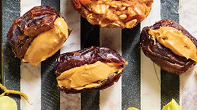 Peanut Butter Stuffed Dates on a black and white striped background