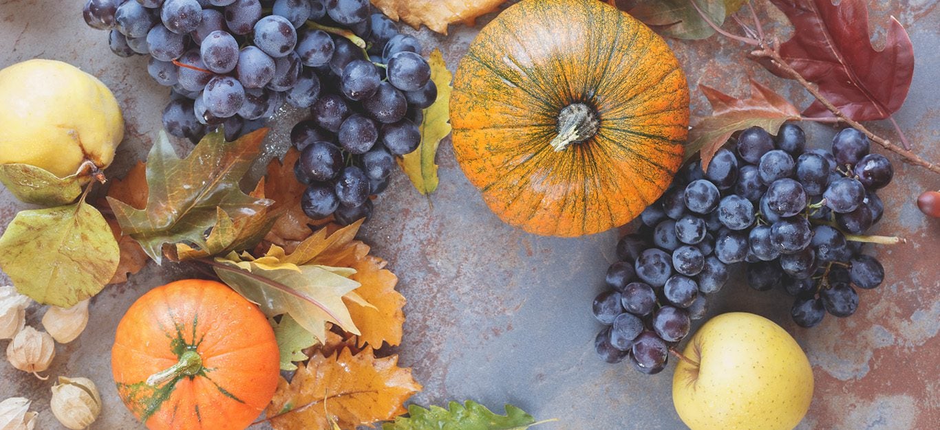 fall fruits and vegetables including pumpkins and grapes
