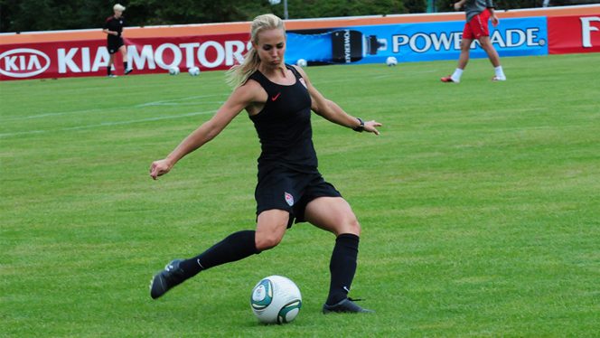 U.S. Olympic Gold Medalist Heather Mitts Prepares to Kick a Soccer Ball