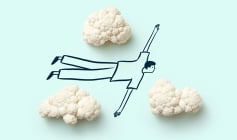 cartoon man flying between cauliflower florets that represent clouds