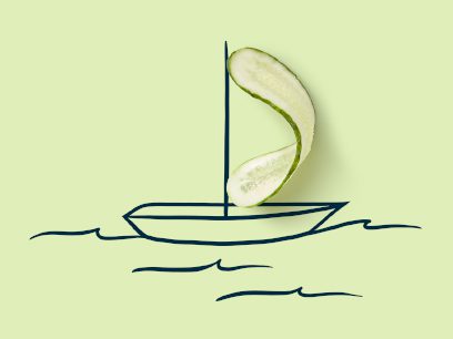 A cartoon sailboat with a cucumber slice for a sail