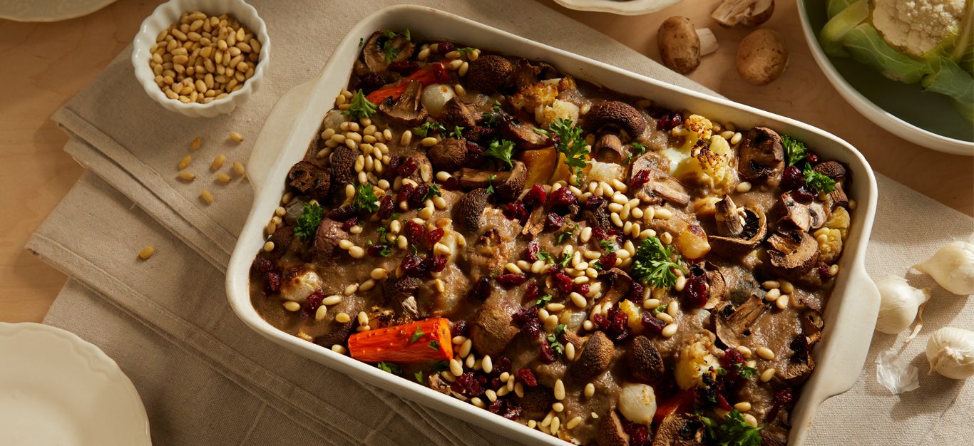 Harvest Vegetable Casserole with Lentils and Gravy in a serving dish