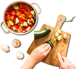 hand chopping zucchini on a cutting board