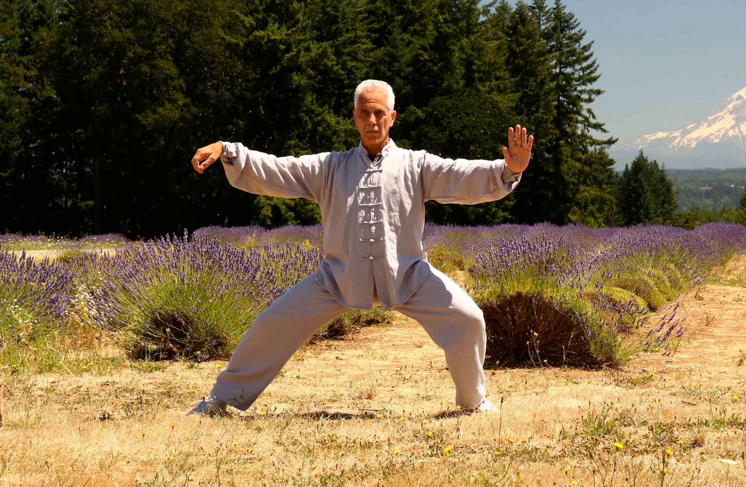 A senior man (Dr. Robert Bacher) practices taiji in a lavender field