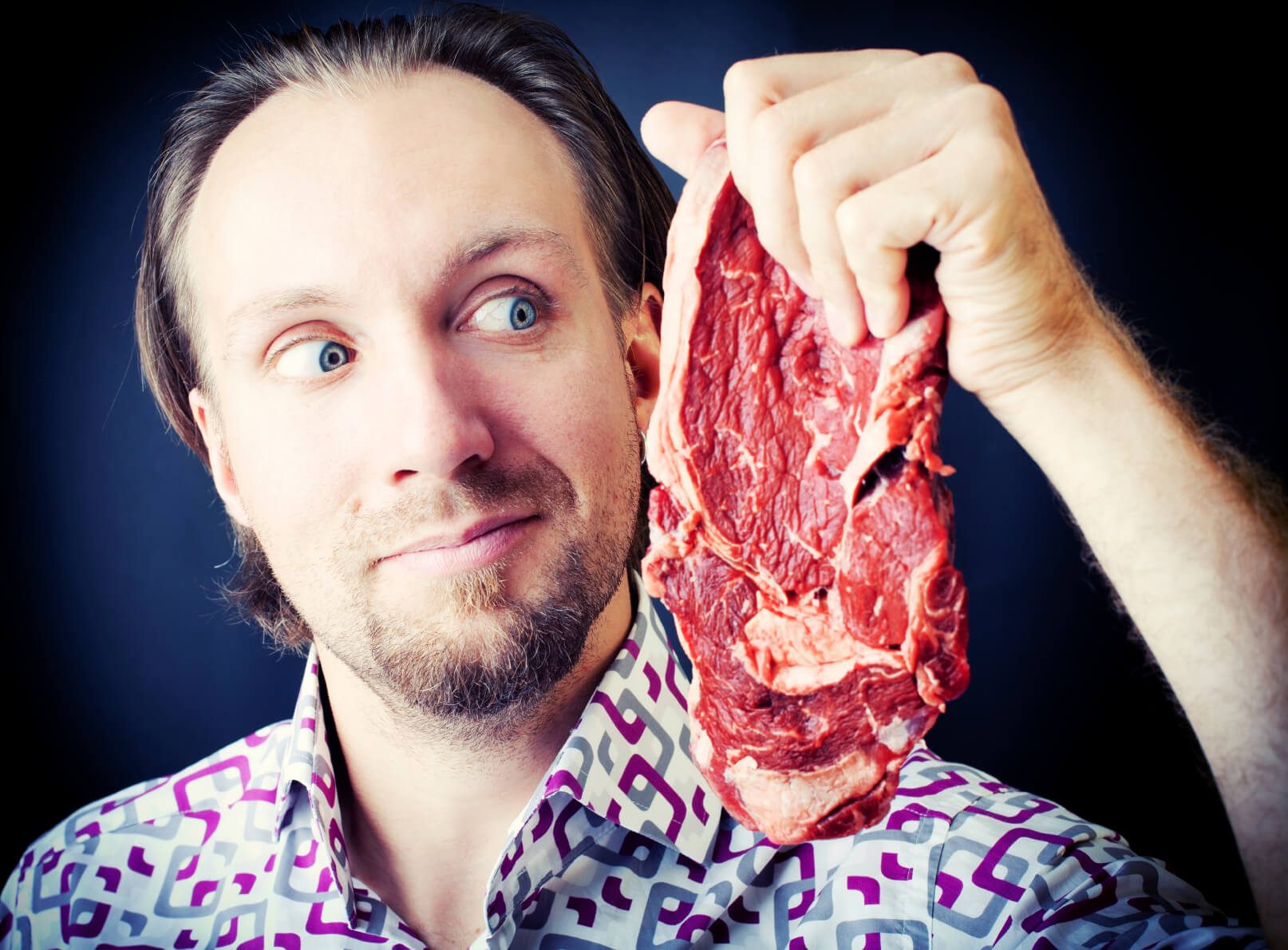 Man holding a raw steak