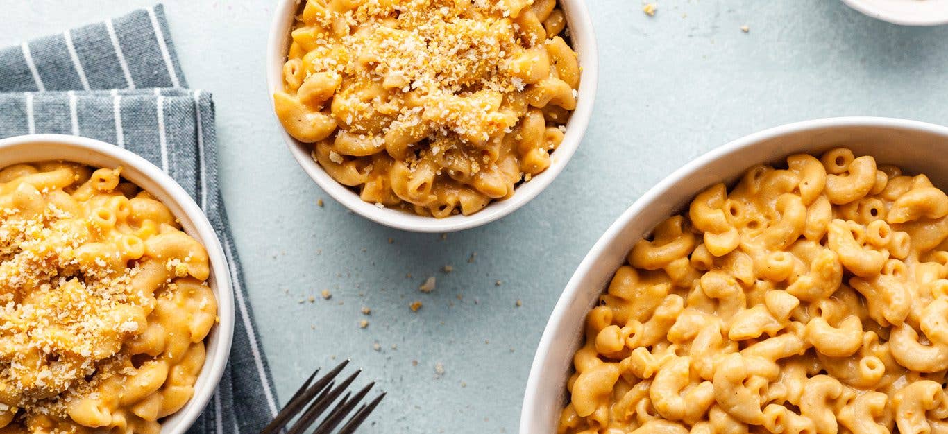 Vegan Instant Pot Mac and Cheese - cheesy mac shown in three bowls, sprinkled with bread crumbs